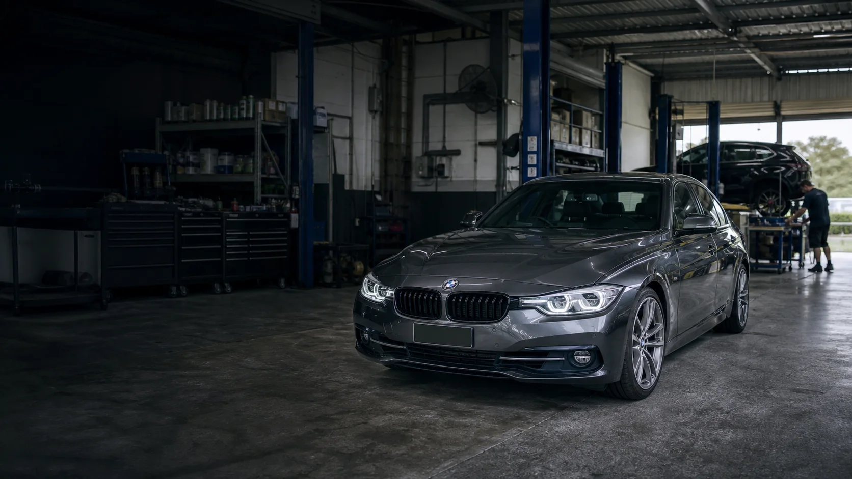 BMW in a practical independent Melbourne workshop with technicians working in the distance